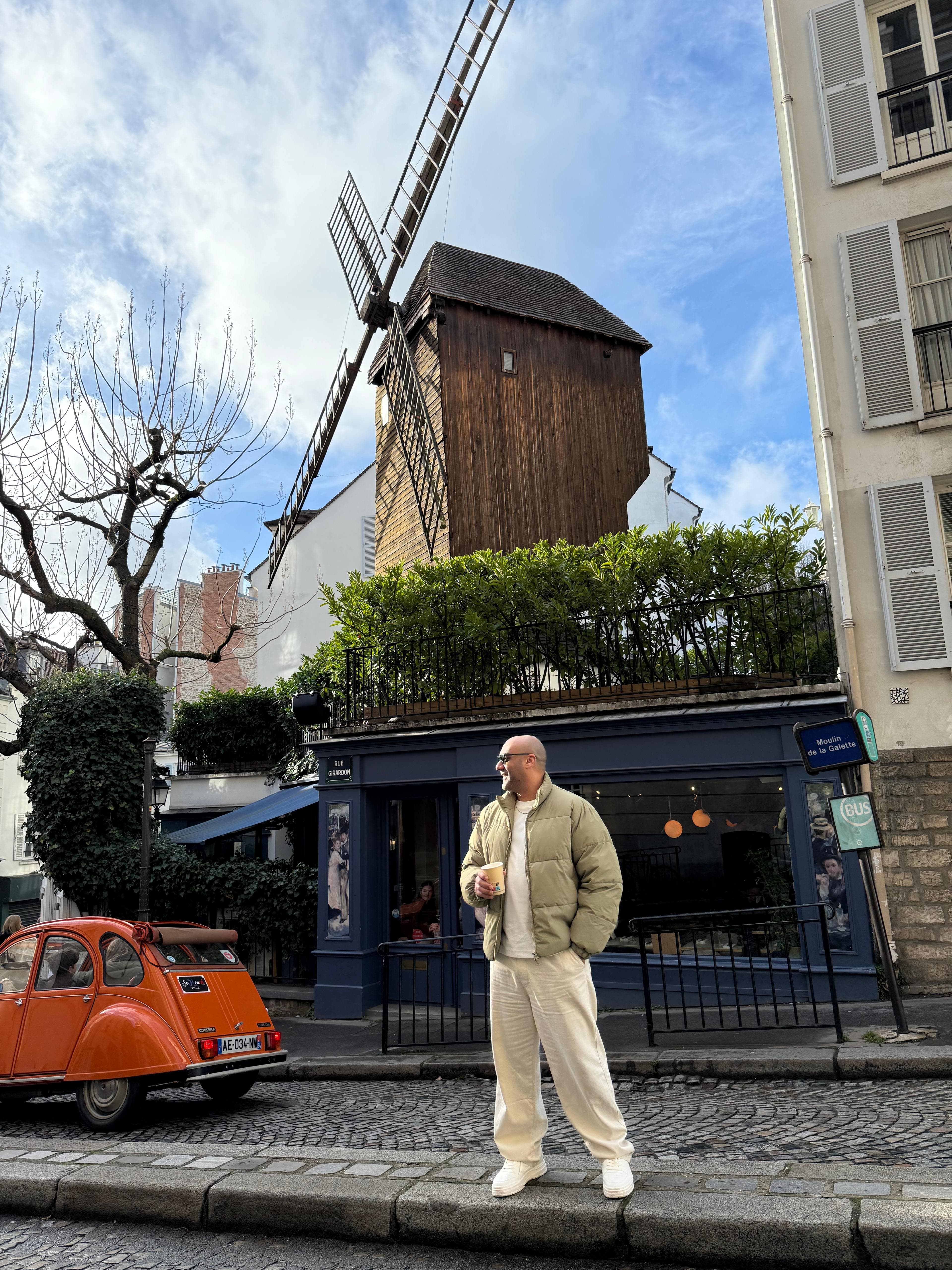 Emad Sharaki in France, standing below a windmill